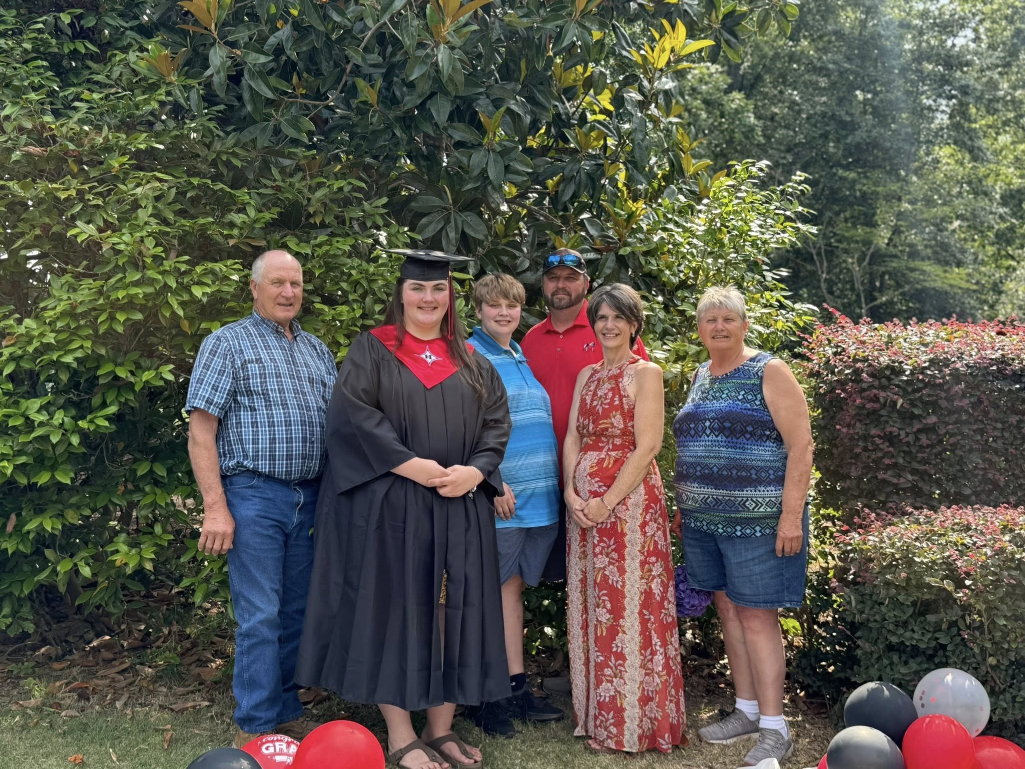 Three generations of the family gathered outside for a graduation photo.