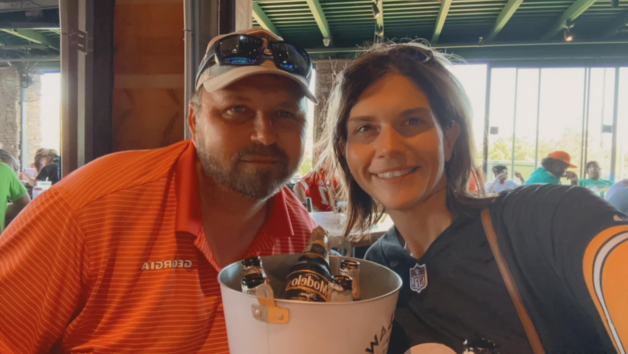 Lindsay and her husband holding up a bucket of the day’s catch.