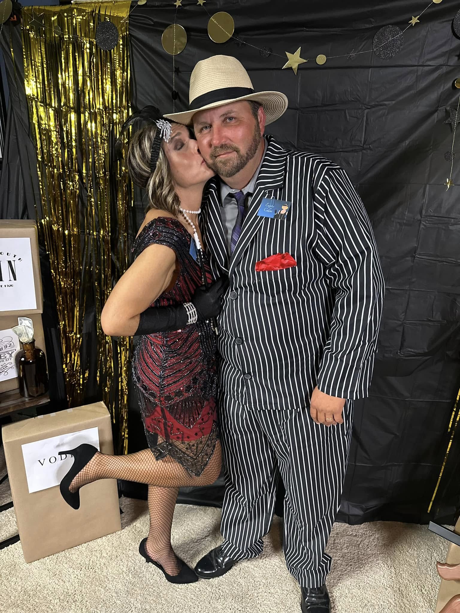 Dressed up for a 1920s-themed party, gold streamers behind us.