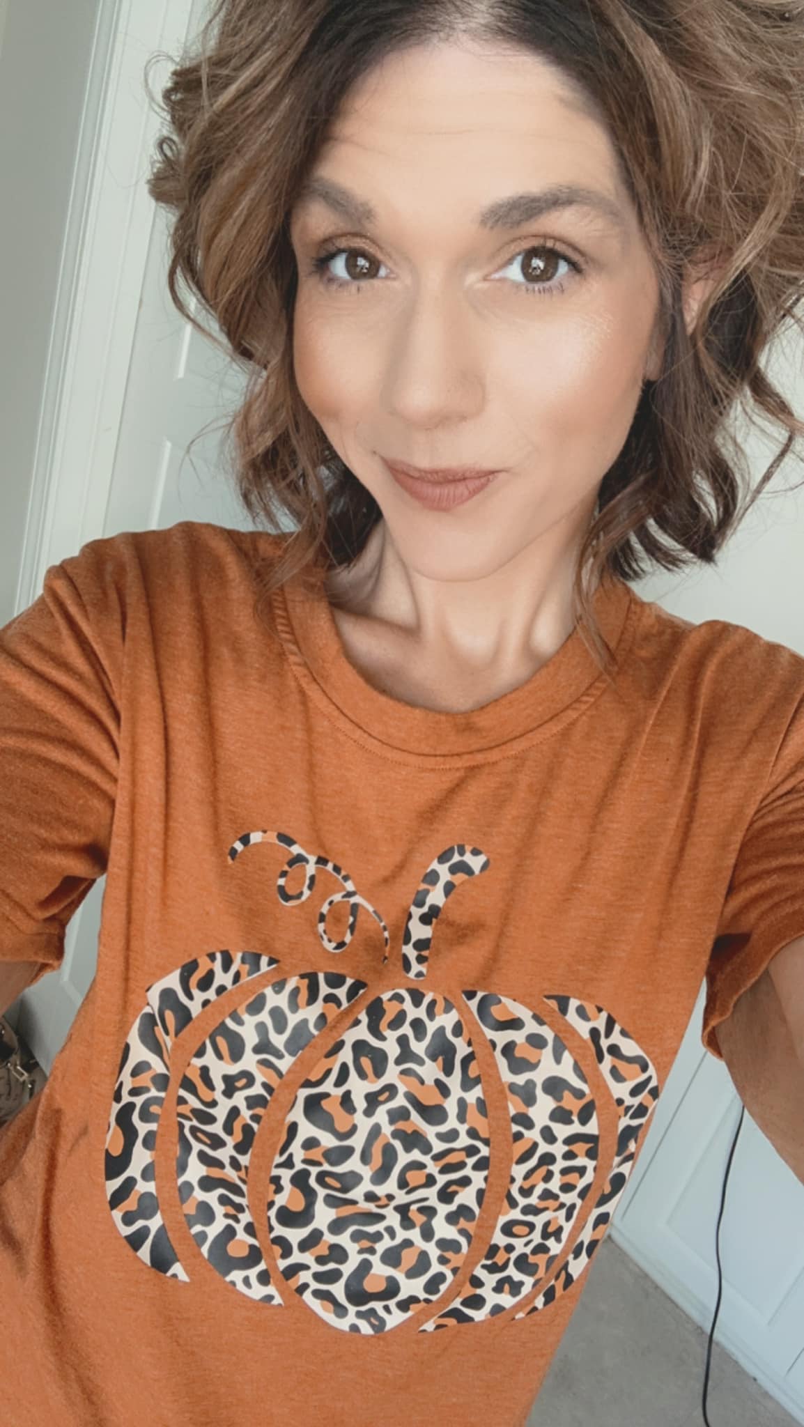 Lindsay in an autumn pumpkin shirt on a fall afternoon.