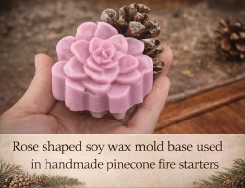 A hand holding the rose-shaped soy wax base used underneath the pinecone fire starters.
